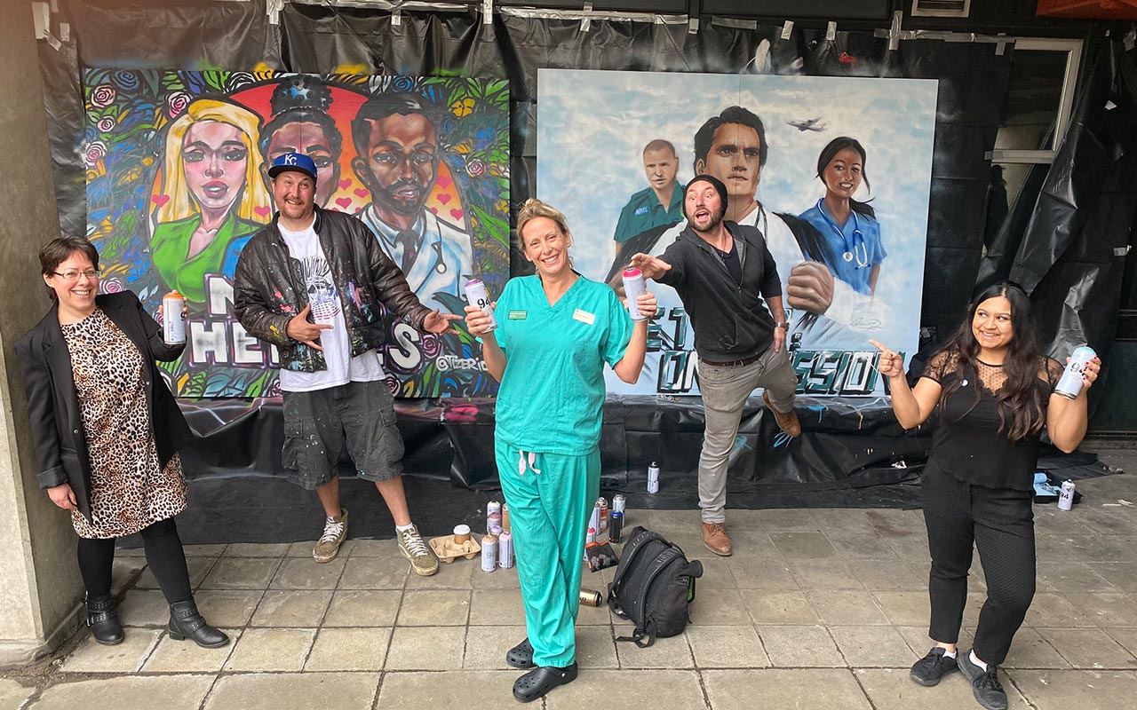 nurse and artists pose with artwork for Oander and the Roayl Free Charity re decoration of ICU ward