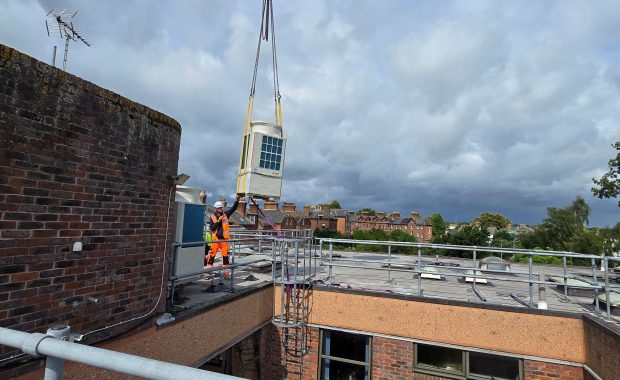 crane moves ac unit durin hvac upgrades at faversham cottage hospital