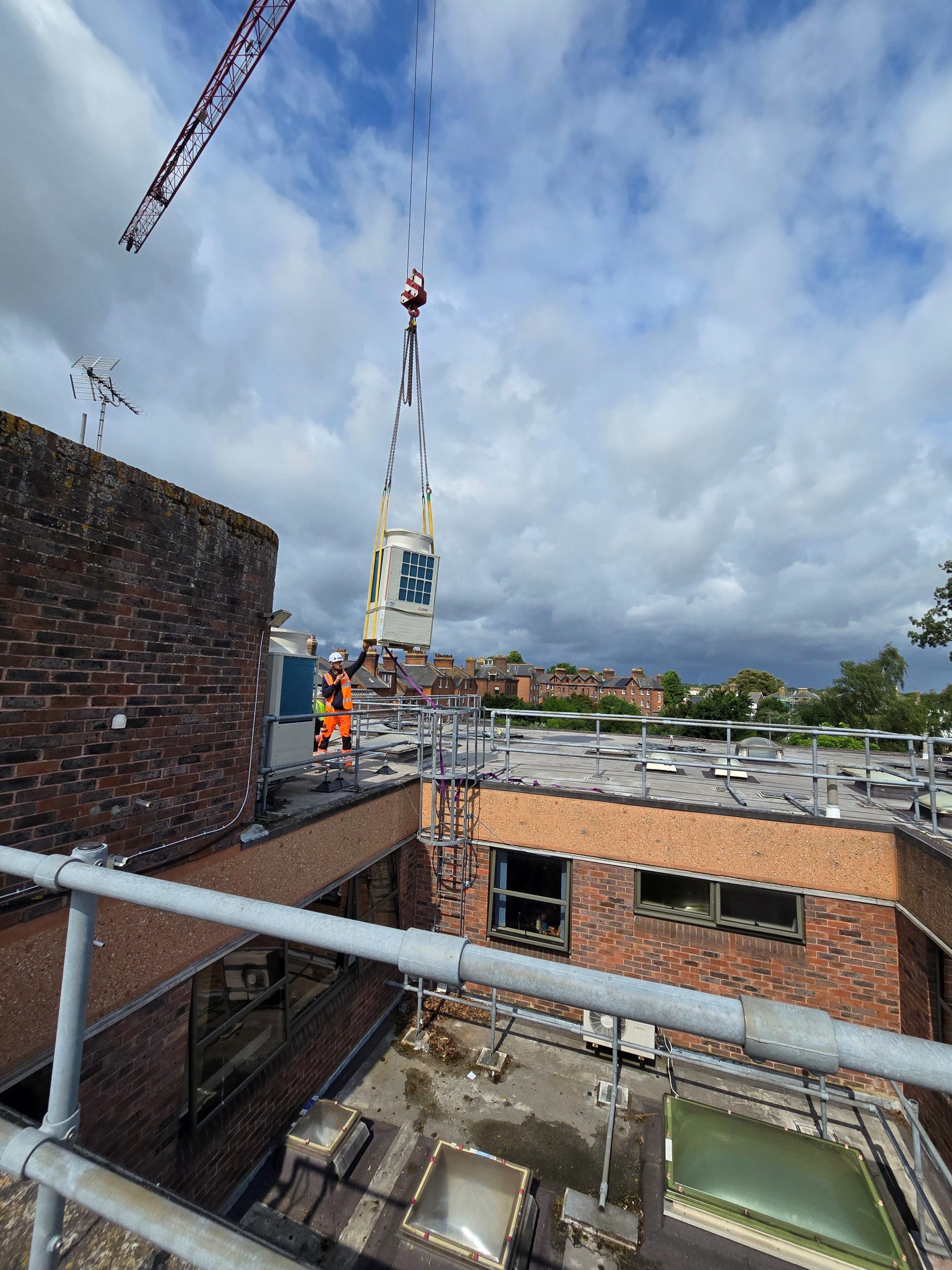 crane moves ac unit durin hvac upgrades at faversham cottage hospital